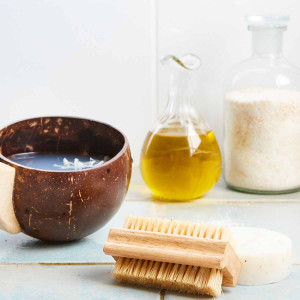 Nail brush made from rubberwood surrounded by bathroom accessories